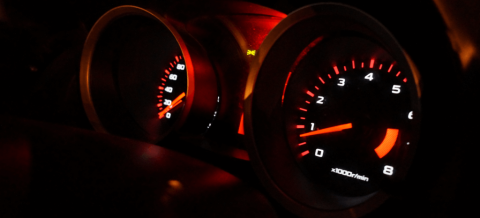 closeup showing a car gauge and speed indicators