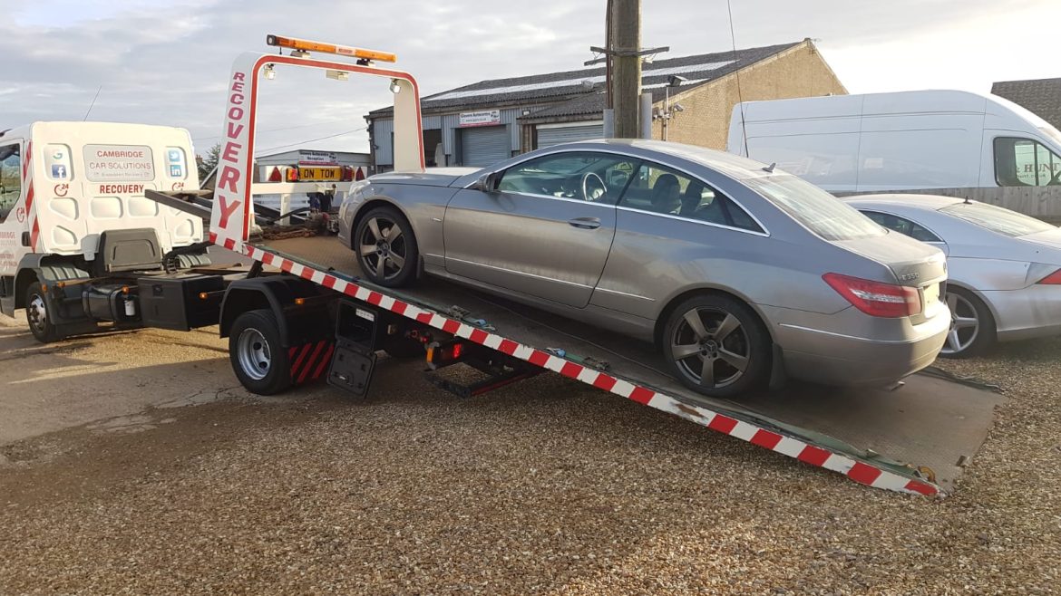 mercedes on a flatbed truck