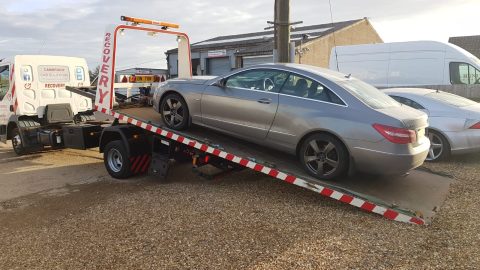 mercedes on a flatbed truck